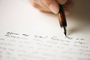 Writing letter to a friend. Selective focus and shallow depth of field. Writing letter to a friend. Selective focus and shallow depth of field.